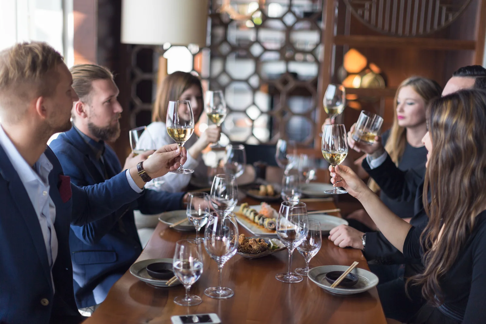 Friends sharing a meal around a restaurant dining table