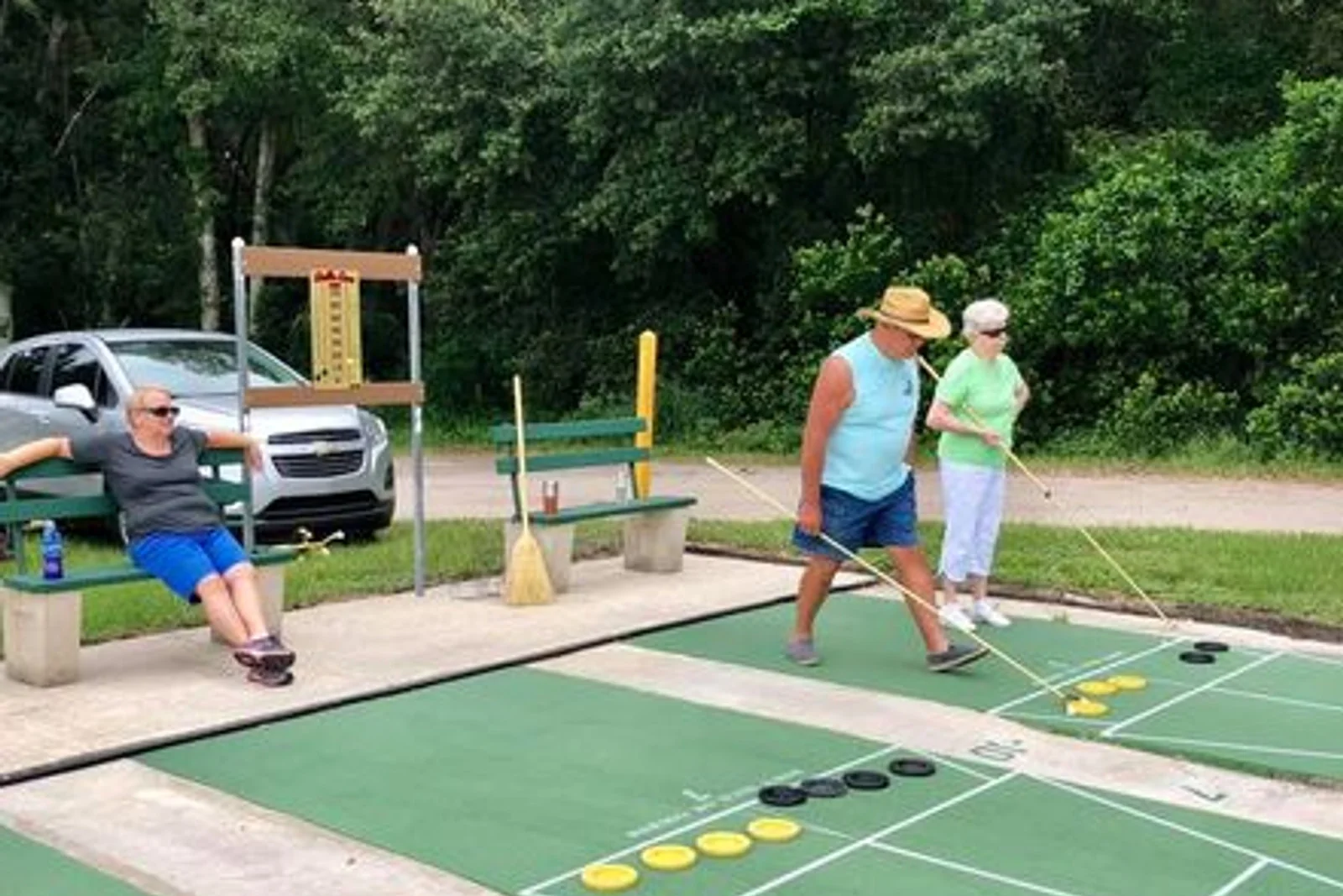Residents playing shuffleboard on the community courts